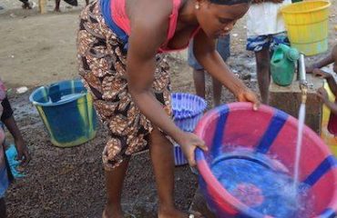Mujer cogiendo agua en Sierra Leona